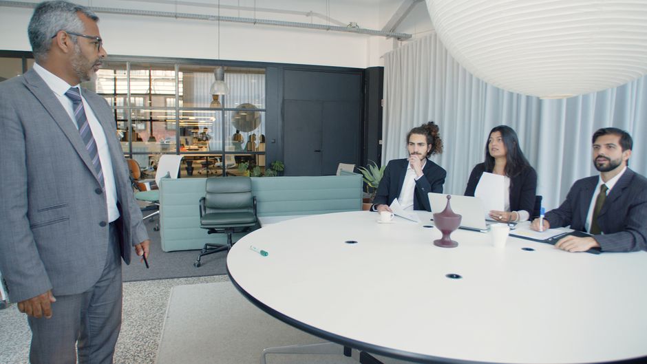 Professional business meeting with executives in a modern conference room
